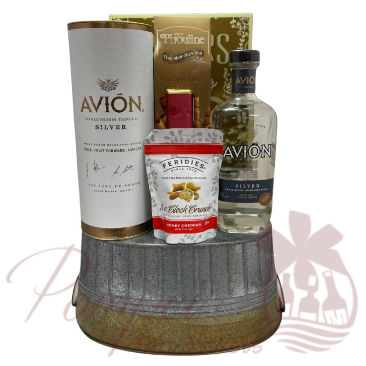 rustic metal container packed with Avion Silver Tequila, cookies, snacks, and chocolates
